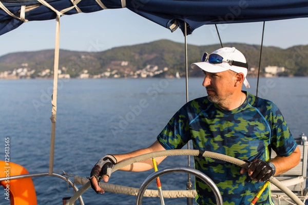 Fototapeta Man skipper during in the yachts boat race, sailing the Aegean sea.