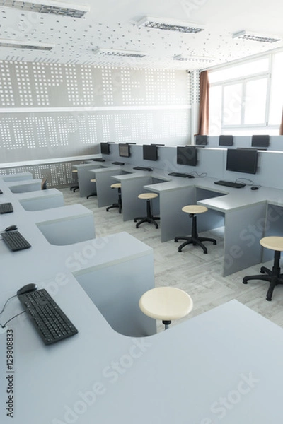 Fototapeta Workplace room with computers in row.