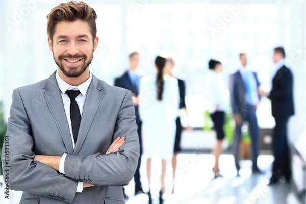 Fototapeta Happy mature business man looking at camera with satisfaction at office