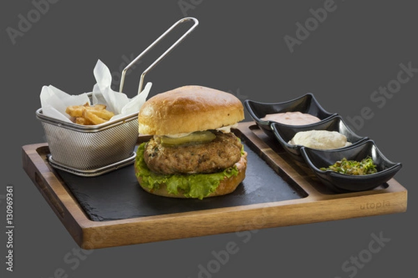 Fototapeta burger patty and garnish with fried potatoes and three kinds of