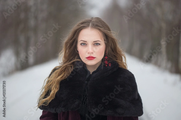 Fototapeta Winter portrait of a girl with long hair