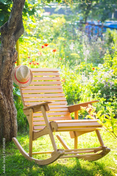 Fototapeta rocking chair in a garden