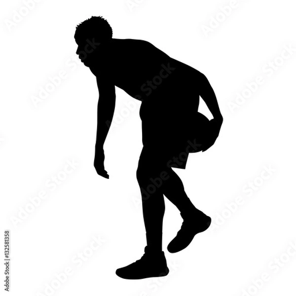 Fototapeta Basketball player standing and dribbling the ball, vector silhou