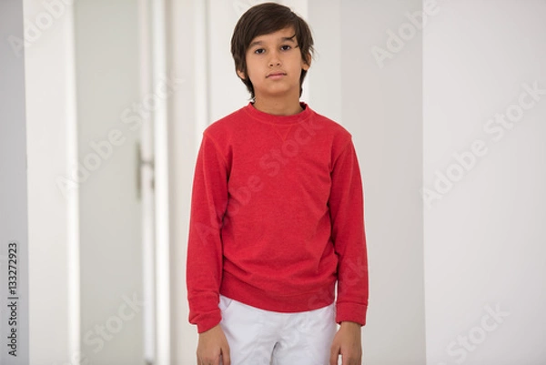 Fototapeta Cute school kid posing in studio with different facial expressio