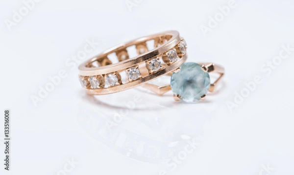 Fototapeta Gold ring with light Topaz and a thick ring with diamonds