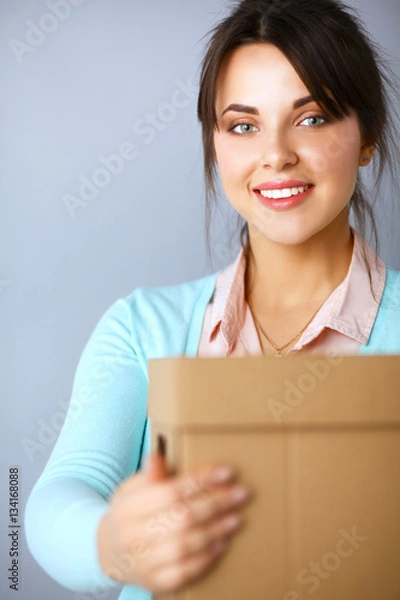 Fototapeta Portrait of pretty woman holding a box