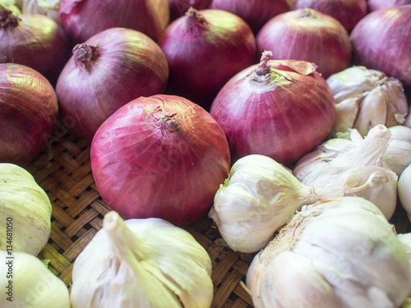 Fototapeta Onions and garlic in basket.