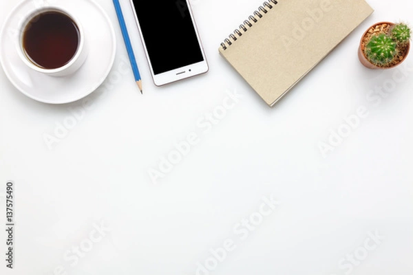 Fototapeta Top view accessories office desk concept.mobile phone,coffee,notepaper,pencil,cactus on office desk.