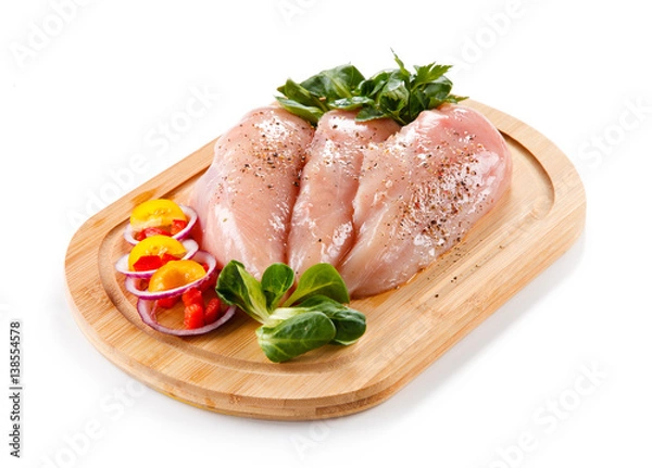 Fototapeta Raw chicken breasts on cutting board 