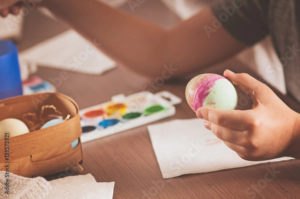 Fototapeta child paint eggs, holy Easter