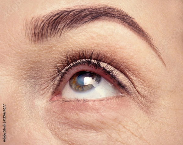 Fototapeta Cataract concept. Senior woman's eye, closeup