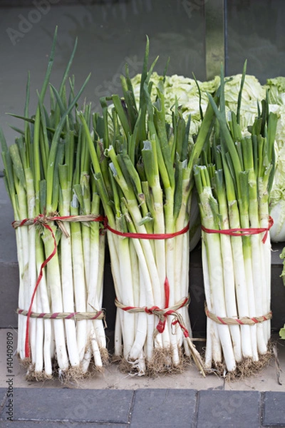 Fototapeta Three bunches of leeks on the market 