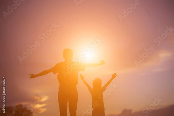 Fototapeta silhouette of a happy children and happy time sunset 