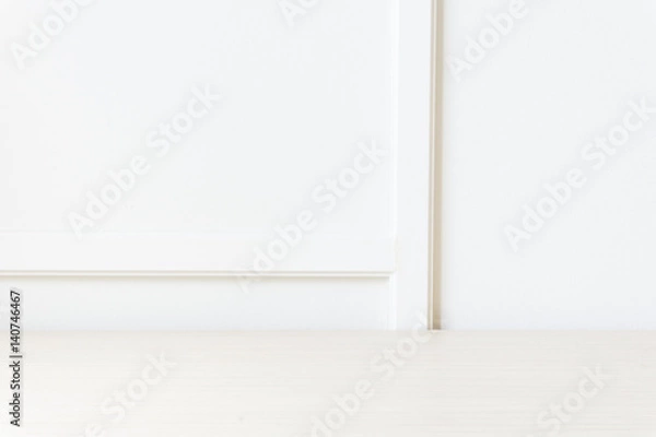 Fototapeta light wooden table in front of wooden white wall with clear light