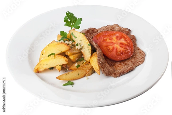 Fototapeta chop steak with French fries tomato and parsley on a plate isolated