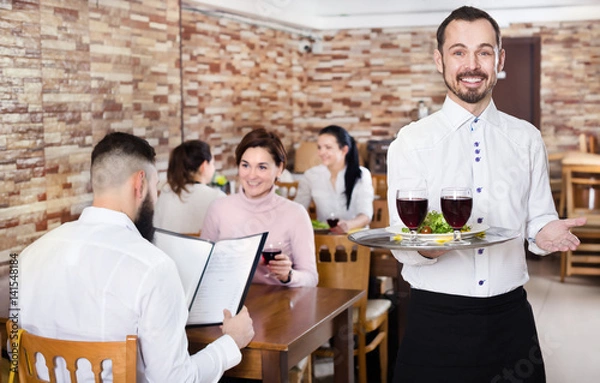 Fototapeta Waiter serving restaurant guests