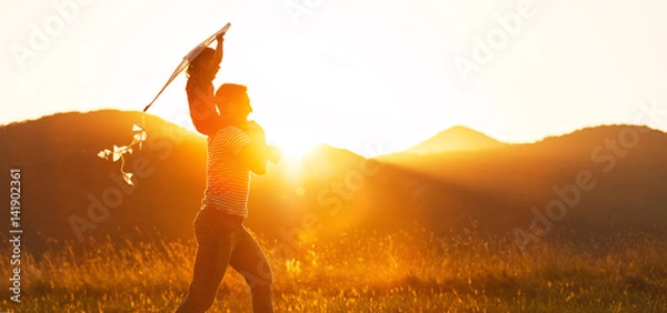 Fototapeta Happy father's day! Child girl and dad with a kite on nature in summer