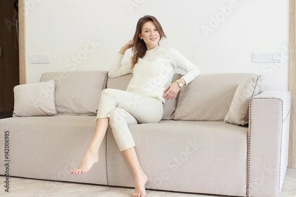 Fototapeta Beautiful young woman watching television