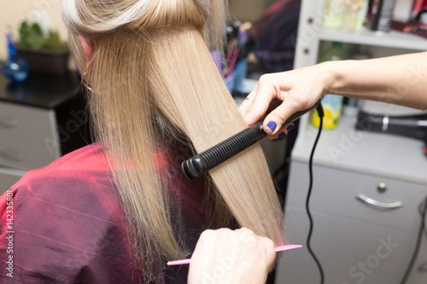 Fototapeta Stylist puts women's hair on a plate