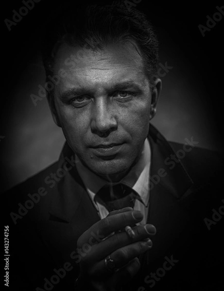 Fototapeta Black and white portrait of a smoking man.