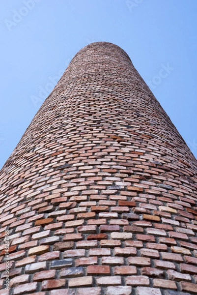 Fototapeta old factory's chimney looks like stairway to infinity