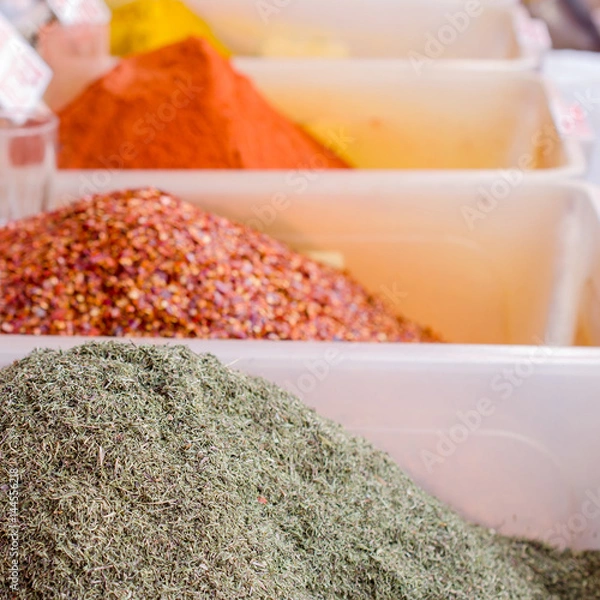 Fototapeta Spices on the market in white containers.