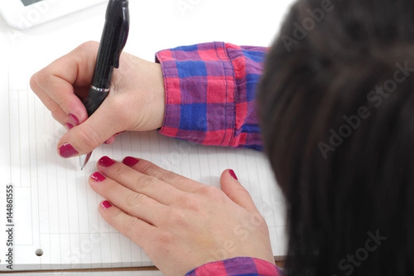 Fototapeta close up of hand of woman taking notes