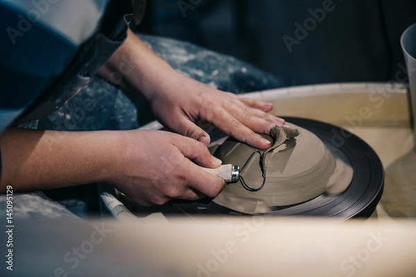 Fototapeta Pottery tool in the hand of potter