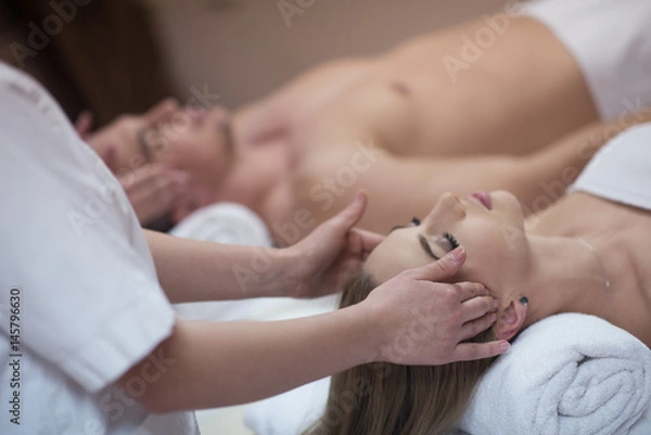 Fototapeta couple enjoying head massage at the spa