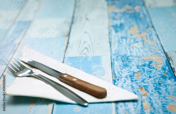 Fototapeta Fork and a knife on a napkin