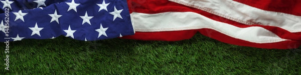 Fototapeta Red, white, and blue American flag on grass for Memorial Day or Veteran's day background