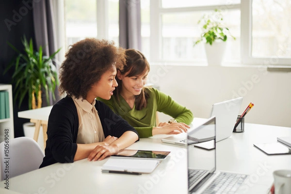 Fototapeta Young women in modern office