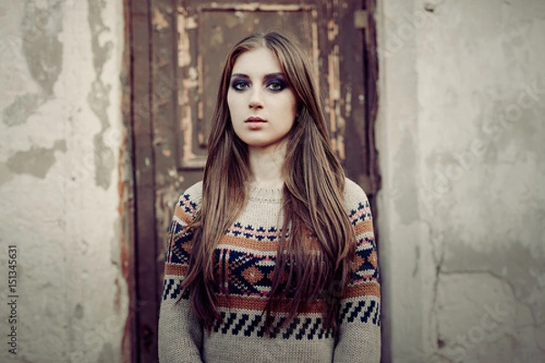 Fototapeta Beautiful Woman with long hair in winter pullover. Healthy hair. Grey background