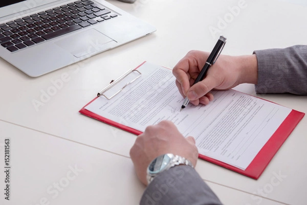 Fototapeta Businessman taking notes at the meeting