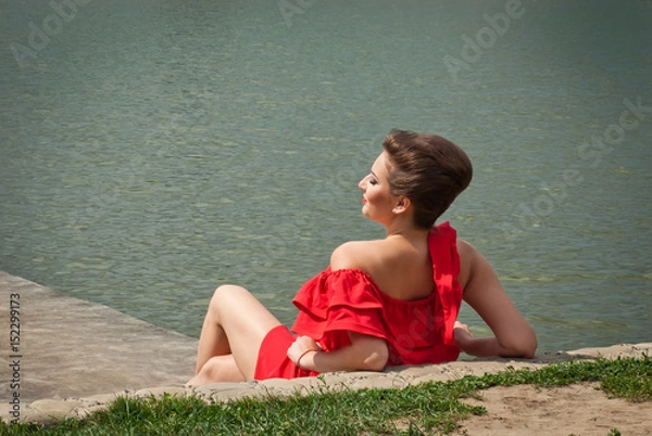 Fototapeta girl on the lake in summer