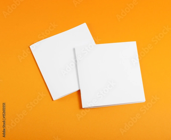 Fototapeta Blank brochure on orange background.