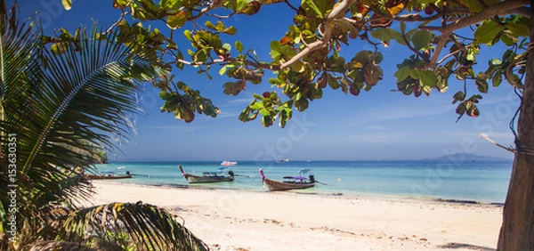 Fototapeta KO PHI PHI, THAILAND, February 2, 2014: Tropical beach with traditional long tail boats on the beach Mosquito island, Ko Phi Phi archiplago, Andaman Sea, famous tourist destination in Thailand