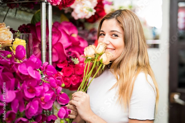 Fototapeta Customer smelling flowers on display