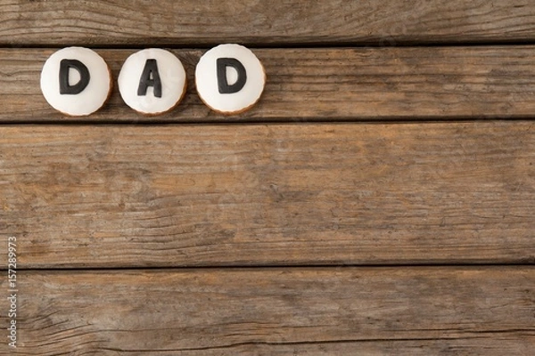 Fototapeta Circle cookies with black dad text on table