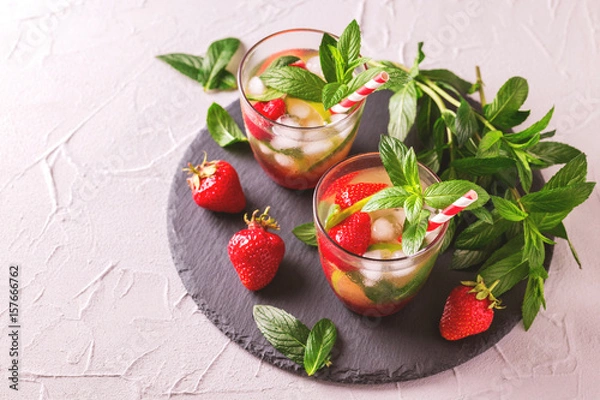 Fototapeta Cold lemonade with fresh strawberry, mint, lime and jam