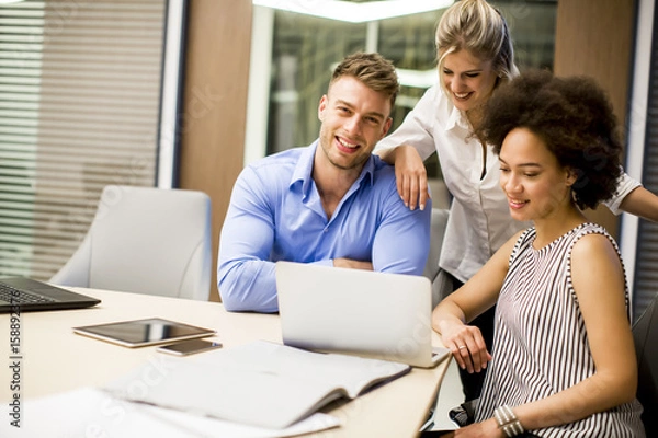 Fototapeta Young multiracial people working in the office