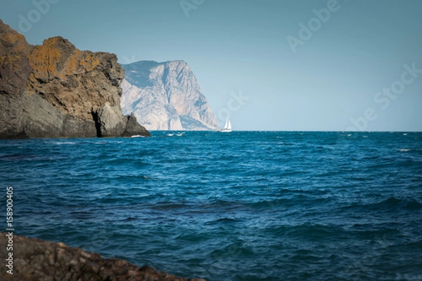 Fototapeta Sea coast and white sailboat in the sea