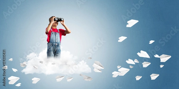 Fototapeta Concept of careless happy childhood with girl looking in binoculars