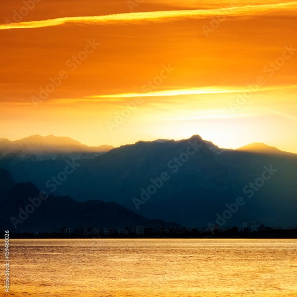 Fototapeta high mountains  over sunset sky