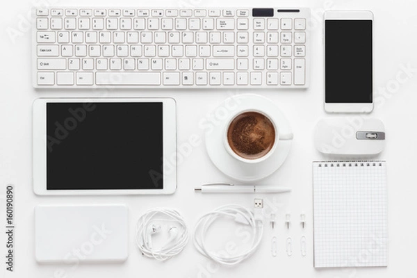 Obraz overhead of essential office objects in order on white desk