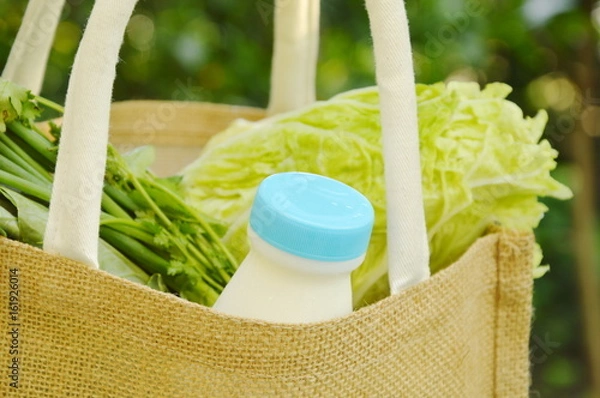 Fototapeta vegetable and milk in shopping fabric basket better than used plastic bag