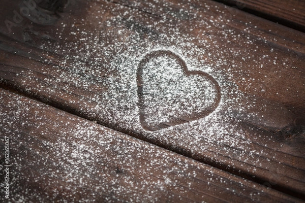 Fototapeta powdered sugar heart on wooden background