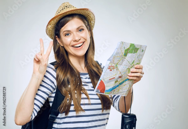 Fototapeta Woman traveler holding paper map