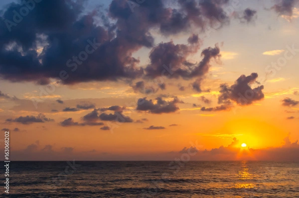 Fototapeta Amazing sea sunset, the sun, waves, clouds