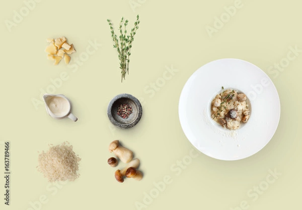 Fototapeta Cooking ingredients for italian risotto with wild mushrooms isolated on yellow